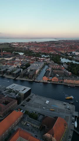 Drone vertical footage of a beautiful neighborhood overlooking the main canal and Langebro "Long Bridge" in Copenhagen, Denmark