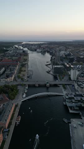 Drone vertical footage of a beautiful neighborhood overlooking the main canal and Langebro "Long Bridge" in Copenhagen, Denmark