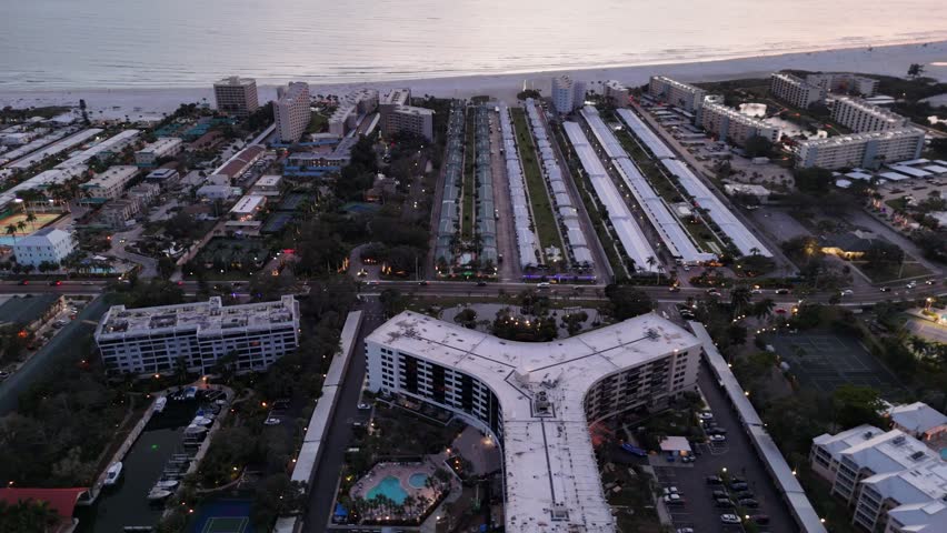 An aerial view of the cityscape of Siesta Key with Siesta Beach in the background at sunset in Florida, USA