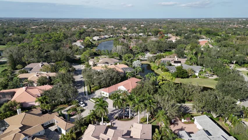 An aerial footage of a residential neighborhood on a sunny day in Siesta Key city, Florida, United States
