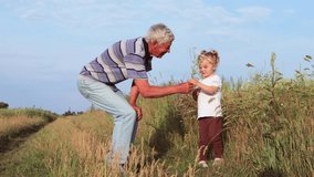 Old grandfather with silver hair enjoying his time with his curly-haired carefree granddaughter outside in green meadow in the countryside during smelling field flowers warm summer afternoon - Powered by Shutterstock - Get 15% off with code: PIKWIZARD15