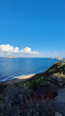 Stromboli vulcano view from Panarea, blu sea and white clouds, Sicily