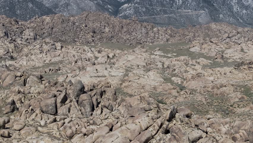 Aerial pan up reveal of Mount Whitney, California from the Alabama Hills during the daytime.