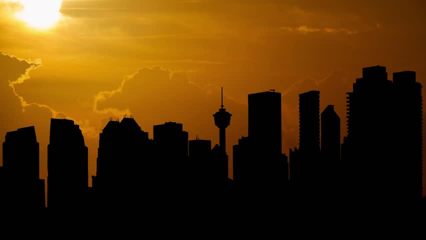 Calgary Skyline at Sunset, Time Lapse with Red Sun and dramatic cloudy sky, Alberta, Canada