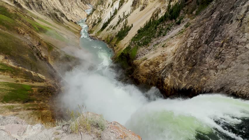 Yellowstone Park with rushing geysers, multicolored hot springs, crystal clear lakes and impressive canyons. Bears and bison. Wyoming, Idaho and Montana. Yellostone natural spectacle. Sunset.