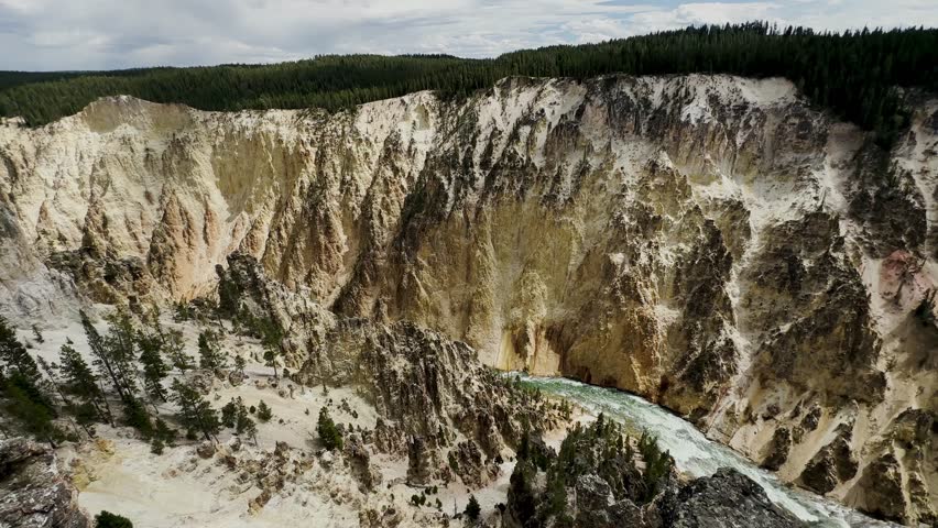 Yellowstone Park with rushing geysers, multicolored hot springs, crystal clear lakes and impressive canyons. Bears and bison. Wyoming, Idaho and Montana. Yellostone natural spectacle. Sunset.