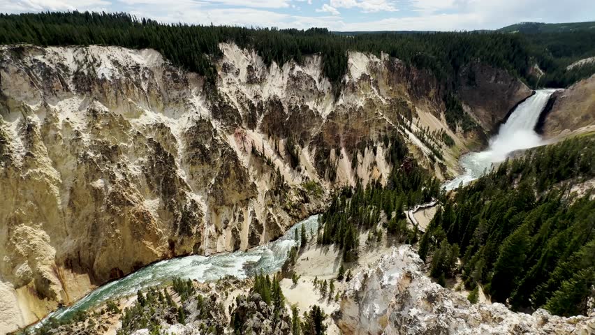 Yellowstone Park with rushing geysers, multicolored hot springs, crystal clear lakes and impressive canyons. Bears and bison. Wyoming, Idaho and Montana. Yellostone natural spectacle. Sunset.
