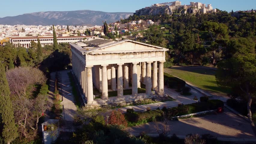 Temple of Hephaestus with the background of the city of Athens. Well-preserved artistic cultural heritage that attracts tourists in the summer period for a trip to discover the beauties of Greece.