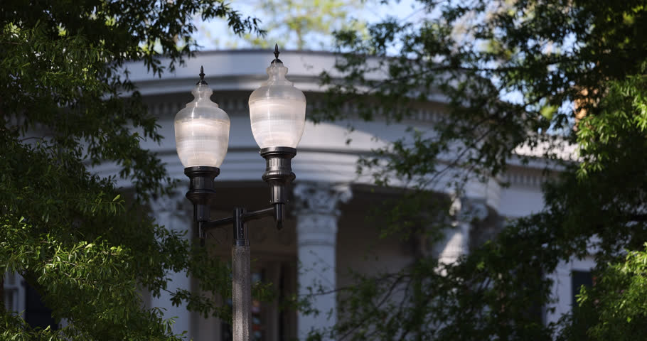 Sunset view of a historic street lamp and downtown buildings of Jackson, Mississippi, USA.