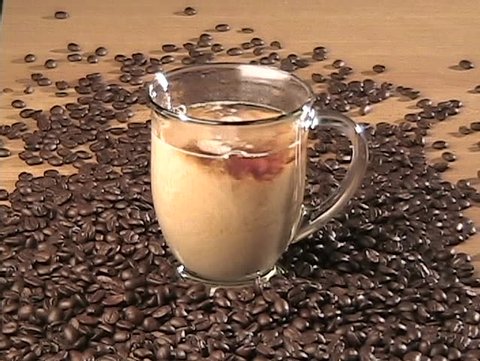 Creamer pouring into coffee.