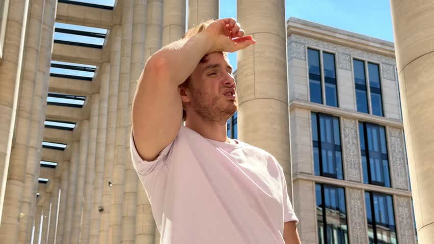 tired sick exhausted man is suffering from hot Summer heat stroke, sunshine, hot weather day, sweaty and thirsty, high temperature. Feeling unwell, unhealthy