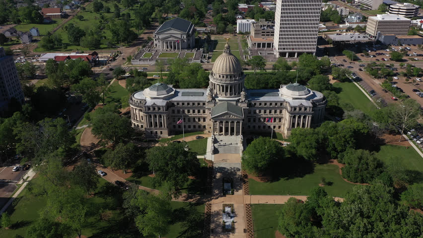Jackson, Mississippi, USA - April 23, 2024: Afternoon light shines on the historic Capitol and buildings of downtown Jackson skyline.