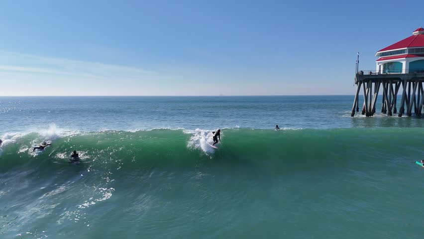 Huntington Beach drone footage. Depicts a surfer surfing
