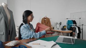 Online consultation with dressmaker, Asian woman designer talking by video call. Portrait of professional seamstress in tailor-made atelier, senior Chinese lady consulting customer, showing fabric - Powered by Shutterstock - Get 15% off with code: PIKWIZARD15