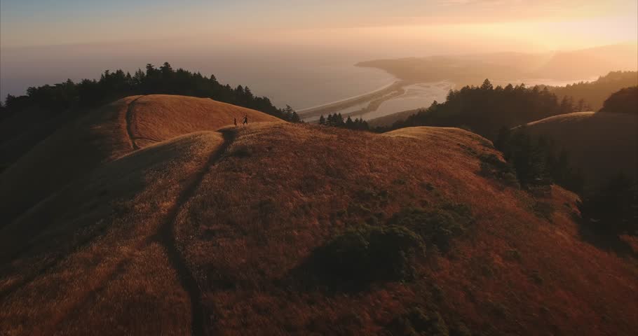 Male and female ballet dancer doing contempoary dance on dry grassy hills in Mt Tamalpais as sunset. San Francisco, California, United States of America.