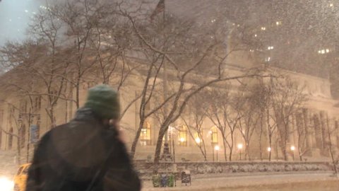 Heavy Snow falling in front of the public Library on 42nd and 5th in New York City during the evening in the middle of winter