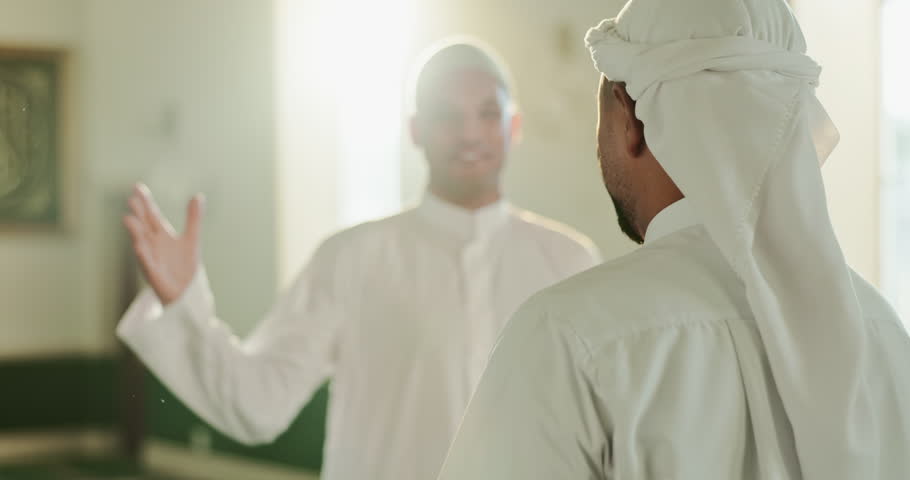 Muslim, hello and men hug in mosque for community, support and greeting for Islamic leader. Holy temple, prayer and people in religious building for Ramadan Kareem, Eid Mubarak and praying together