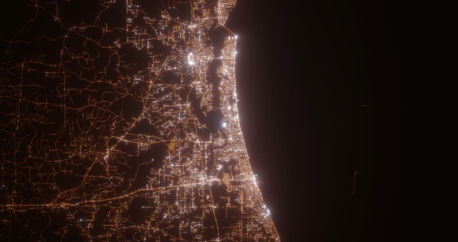 Biloxi (Mississippi, USA) top view at night. Aerial view on modern city from space. Camera is flying above the city, moving forward. Vertical video. The north is on the left side