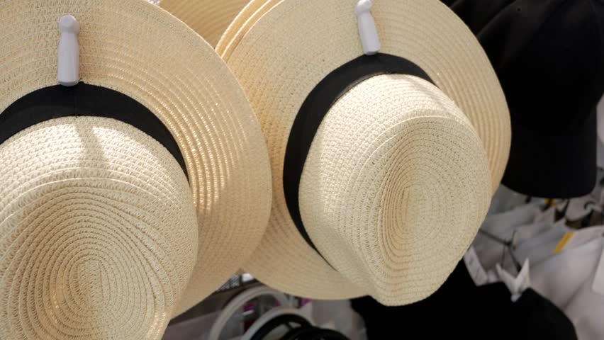 Summer headdress. Headwear. Headgear. New seasonal collection of straw hats on shelves, display for sale in the headdress shopping store. Clothing store showcase with variety of caps and hats - Powered by Shutterstock - Get 15% off with code: PIKWIZARD15