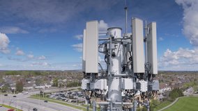 An aerial view of 5G radio network telecommunication equipment with radio modules and smart antennas mounted on a metal on a sunny day - Powered by Shutterstock - Get 15% off with code: PIKWIZARD15