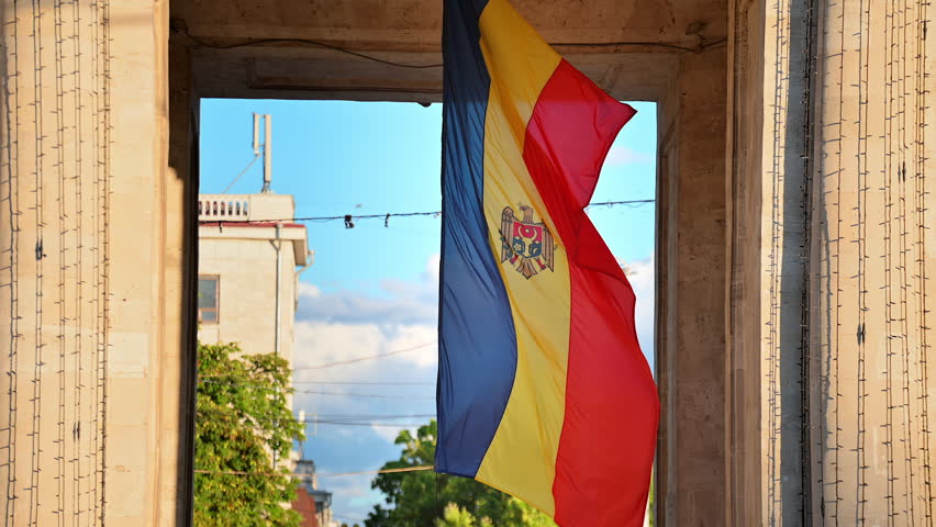 Close view of a waving in the wind national flag located under the Triumphal Arch in Chisinau, Moldova