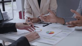 Close-up of hands collaborating on business documents during an office meeting, discussing data and exchanging pens. Ideal for business, teamwork, and corporate concepts - Powered by Shutterstock - Get 15% off with code: PIKWIZARD15