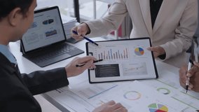 Business professionals analyzing financial data on a tablet and documents, discussing graphs and charts during a meeting in a modern office - Powered by Shutterstock - Get 15% off with code: PIKWIZARD15