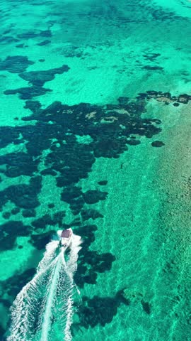 Aerial view of speedboats in crystal clear water near Marathonisi Island, Zakynthos, Greece. Marathon island beautiful turquoise sea water, Zante, Ionian sea.
