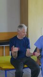 Elderly people at the gym training and improving health. Vertical Video
