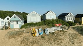 4k video of drone panning across beach huts in Mudeford, Dorset