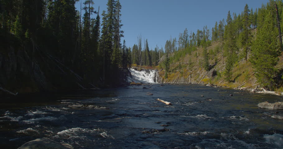 Zoom in and wide shot of Lewis Falls in Yellowstone National Park, Wyoming, USA