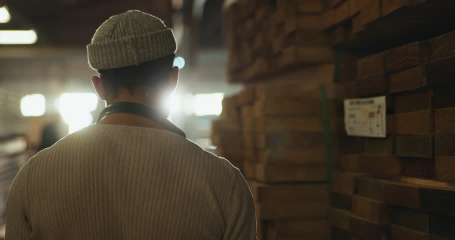 Man, carpenter and inspection on wood with tablet at warehouse in woodwork, research or inventory at workshop. Crafter or handyman checking material, supply or counting stock on technology in storage