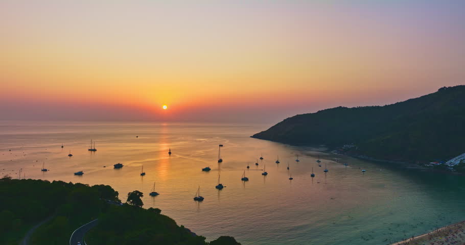 
Aerial view Beautiful colorful sunset at the sea with dramatic sky over Naiharn beach Phuket.
 Nai Harn beach is a famous landmark and popular sunset viewpoint of Phuket Thailand.
