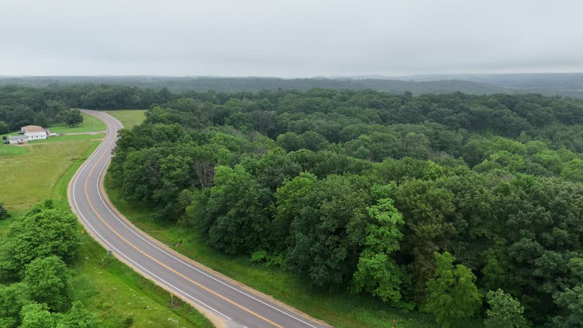 Drone footage of the rolling hills in Western Wisconsin. Country scene with barns, trees and country road