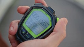 Hand pressing sport timer on race competition. Closeup man holding stopwatch with precise timing results. Unrecognisable coach using technology for fitness monitoring. Athlete performance outdoor - Powered by Shutterstock - Get 15% off with code: PIKWIZARD15