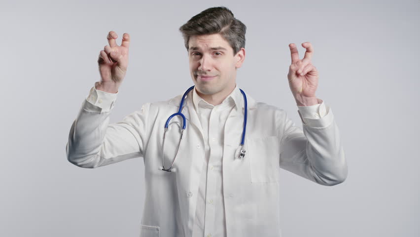 Mature doctor man with hands two fingers air quotes gesture on white, sarcasm