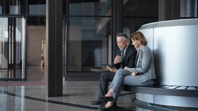 4K Senior businessman and businesswoman executive manager working and discussion together for business project outside office building. Business people teamwork meeting corporate business in the city. - Powered by Shutterstock - Get 15% off with code: PIKWIZARD15