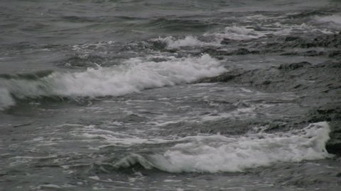 waves crashing into a stony coast