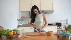 Young chef skillfully chopping fresh vegetables in a bright modern kitchen. Perfect for culinary, healthy eating, and lifestyle concepts - Powered by Shutterstock - Get 15% off with code: PIKWIZARD15