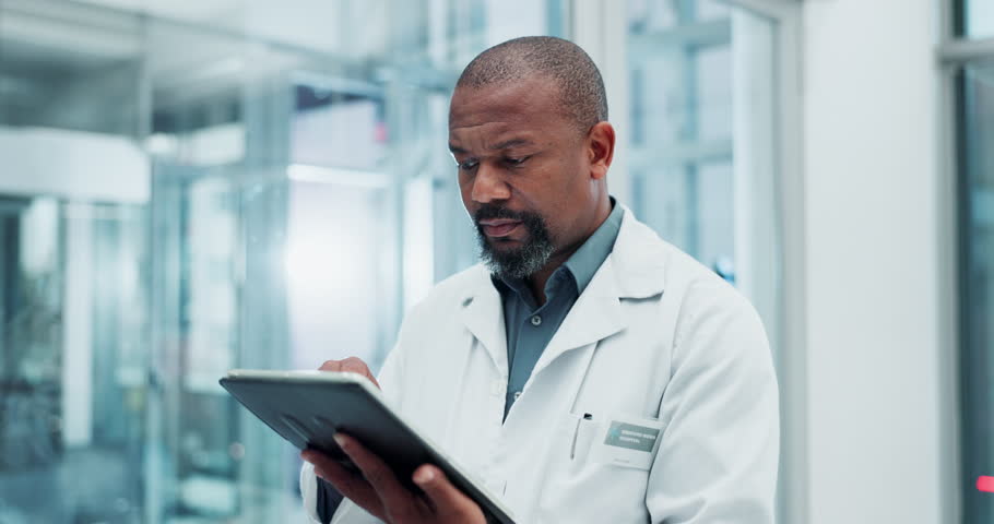 Black man, doctor and tablet in clinic for healthcare, appointment and schedule for telehealth. Technology, medical professional and online for advice, results and patient records in hospital