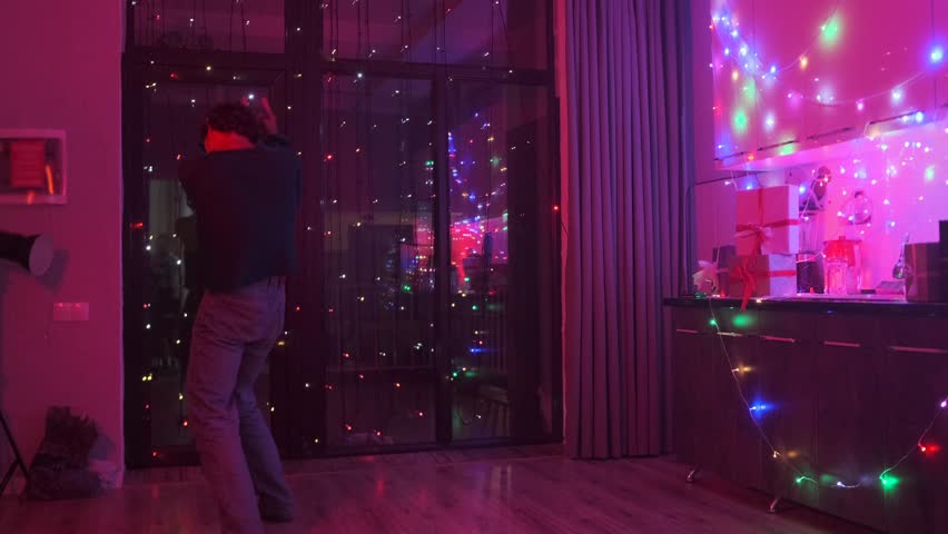 A young guy, a student, spinning in a dance at a house party dedicated to birthday, Christmas, end of the school year, passing the exam. Slow motion.