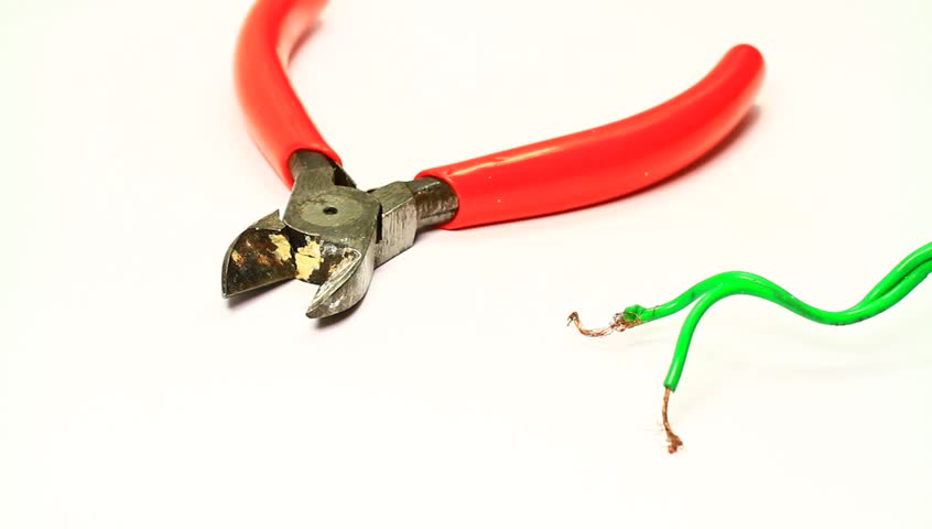 Electrician cutting the cable end using a stripper cutter on white background 
