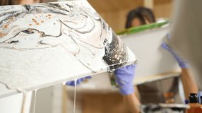 Group of Asian generation z people learning acrylic pouring art on canvas workshop at art studio. Young artist university student enjoy and fun creating colorful abstract modern art painting in class. - Powered by Shutterstock - Get 15% off with code: PIKWIZARD15