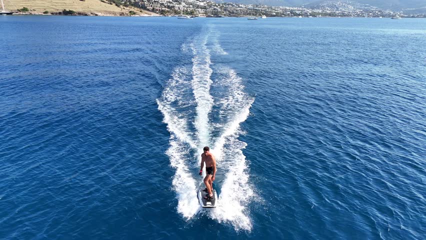 Young man Efoiling around Bodrum Mediterranean coast.