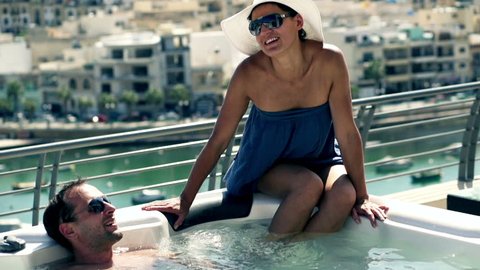 Rich people having fun in jacuzzi, slow motion shot at 120fps
