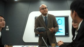 Motivated young business man lead meeting and present using virtual reality technology to diverse colleagues, leader man talking business project discussion with partnership to brainstorm at office.
 - Powered by Shutterstock - Get 15% off with code: PIKWIZARD15