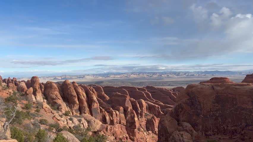 Scenic view from above of the red rock formations and vast landscape in Devil