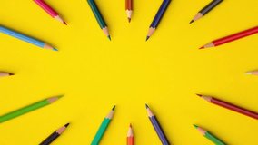 Looping stop motion animation of pencils of different colors moving on yellow paper background with copy space, top view. Back to school concept. Remote education, online study. - Powered by Shutterstock - Get 15% off with code: PIKWIZARD15