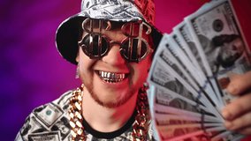 Closeup portrait of happy millionaire smiling broadly by golden teeth, swaying money to camera. Lucky guy win the lottery, successful businessman, blogger or hip-hop star, male person grimacing - Powered by Shutterstock - Get 15% off with code: PIKWIZARD15