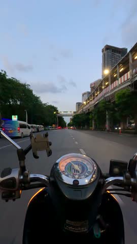 Hyperlapse of scooter riding behind a tuk tuk on the road in Bangkok, Thailand. POV
